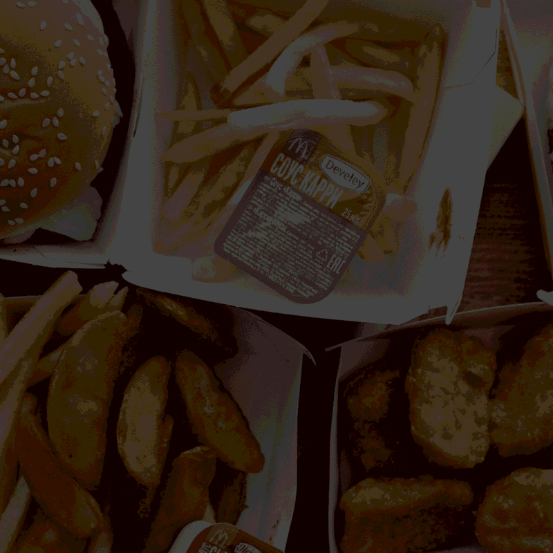 Fast food burgers, french fries, and chicken nuggets in branded packaging, illustrating food licensing and retail-ready products.