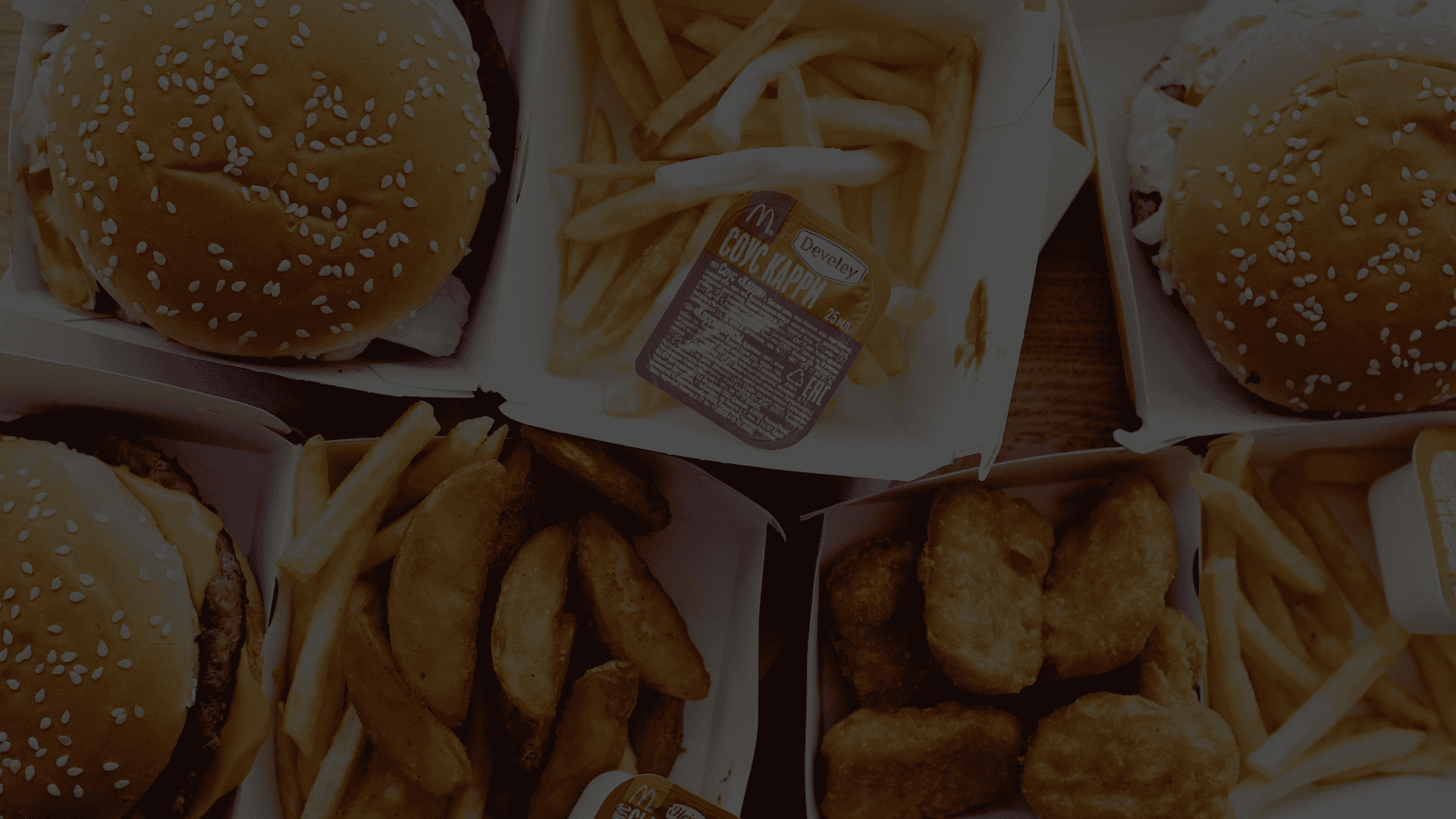 Fast food burgers, french fries, and chicken nuggets in branded packaging, illustrating food licensing and retail-ready products.